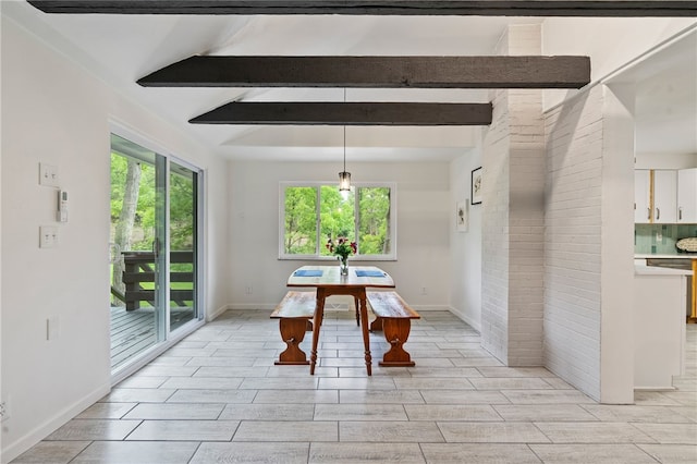 dining room featuring lofted ceiling with beams