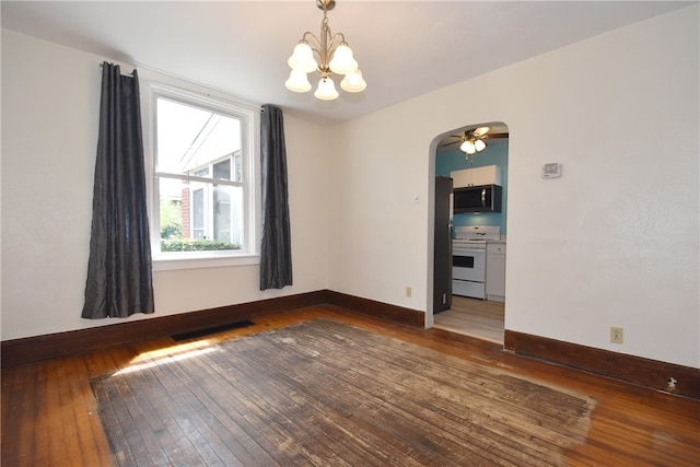 unfurnished room with ceiling fan with notable chandelier and dark hardwood / wood-style floors