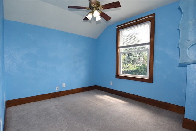 carpeted empty room featuring ceiling fan and lofted ceiling