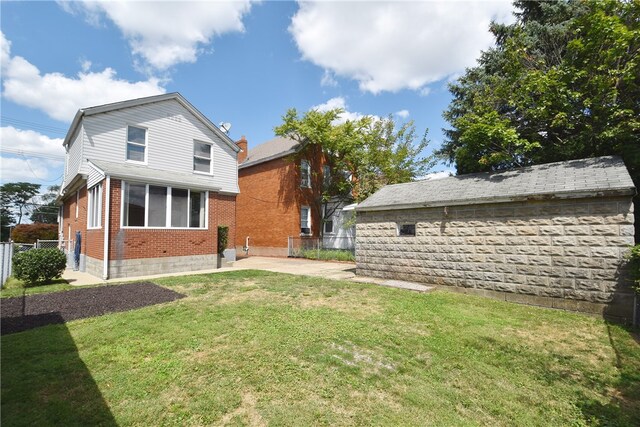 rear view of house featuring a yard