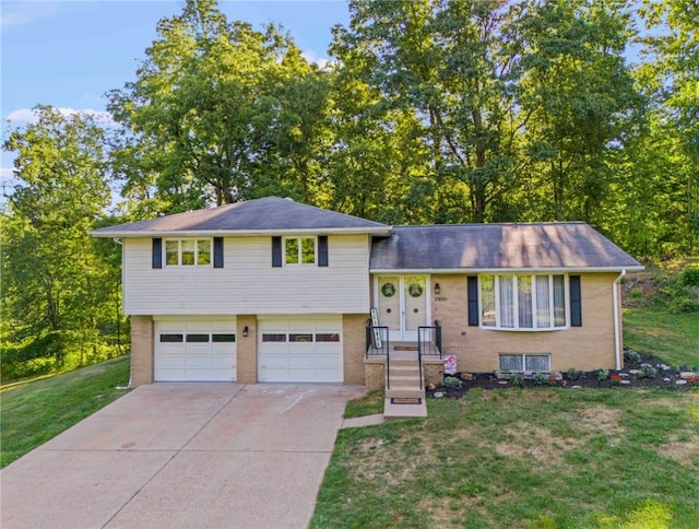 tri-level home with a garage and a front yard