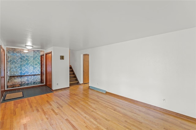 unfurnished living room featuring light wood-type flooring