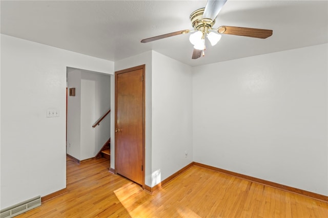 spare room featuring ceiling fan and light hardwood / wood-style floors