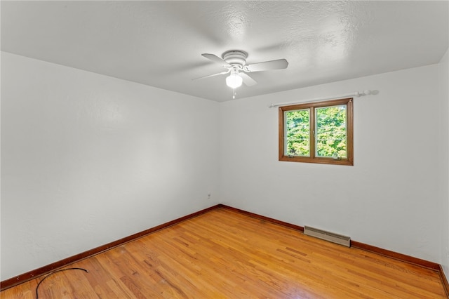 empty room featuring ceiling fan and light hardwood / wood-style floors