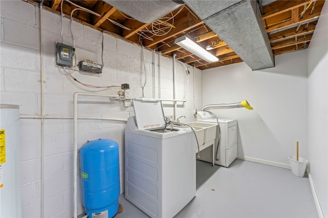 washroom featuring gas water heater, washing machine and clothes dryer, and sink