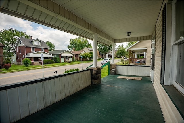 view of patio featuring a garage and a porch