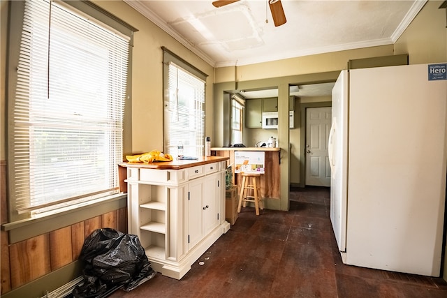 kitchen with ceiling fan, white appliances, dark hardwood / wood-style floors, and a healthy amount of sunlight