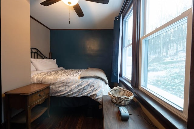 bedroom featuring crown molding, dark hardwood / wood-style flooring, and ceiling fan