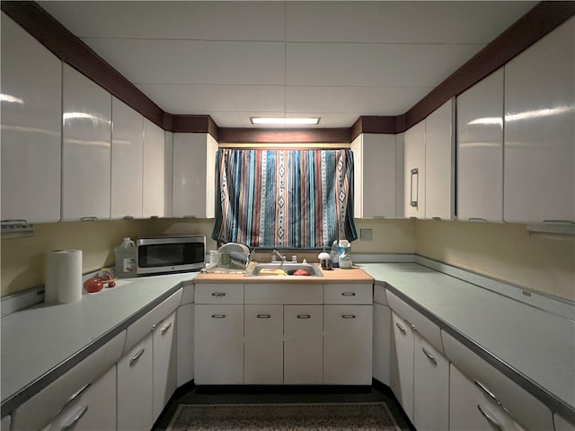 kitchen with white cabinetry and sink