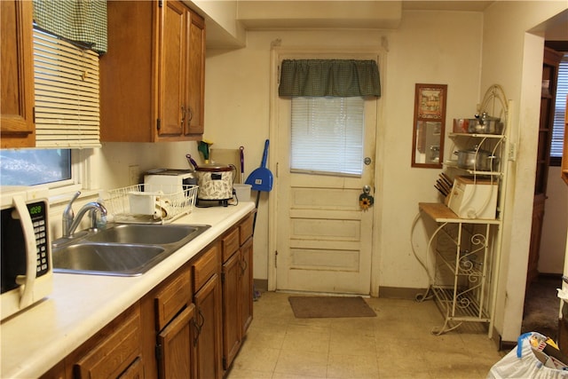 kitchen featuring sink and light tile patterned floors