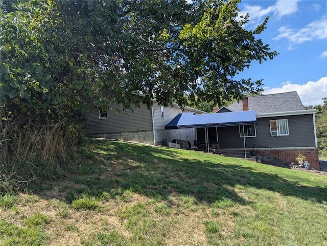 669 Tyrol Blvd, Monessen, PA 15062 - rear view of house with a yard and a chimney