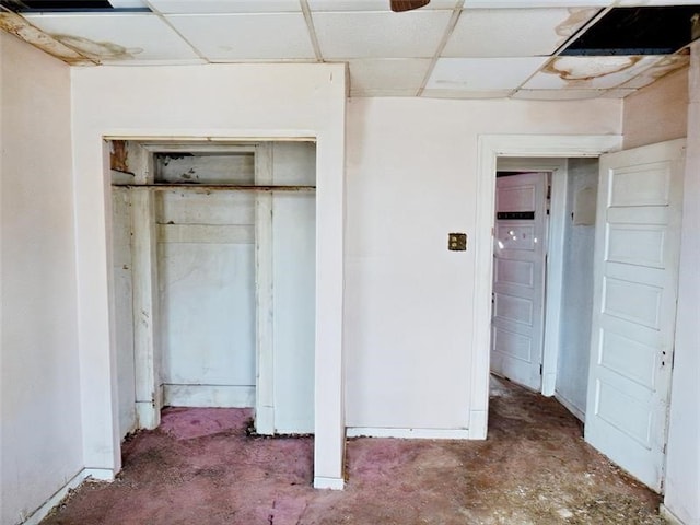 unfurnished bedroom featuring a drop ceiling