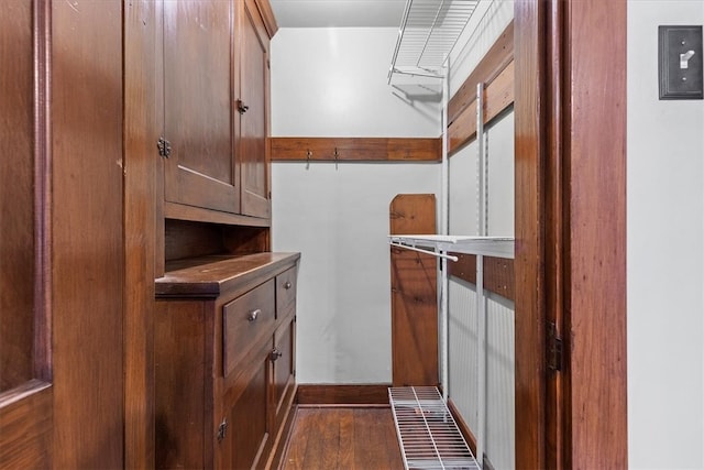 walk in closet featuring dark wood-type flooring