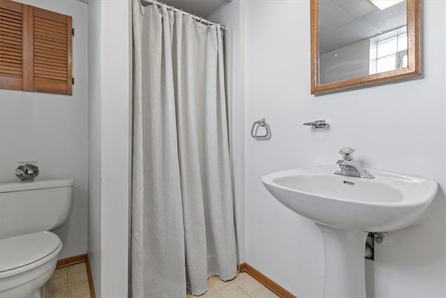 bathroom featuring toilet and tile patterned floors