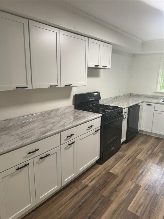 kitchen featuring black appliances, white cabinetry, and dark wood-type flooring