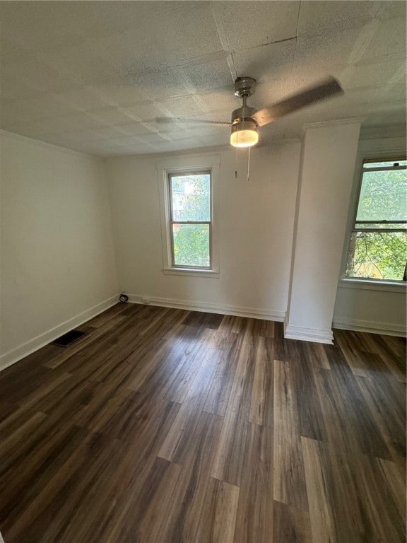 spare room with dark hardwood / wood-style floors and ceiling fan