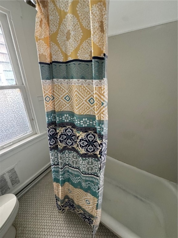 bathroom with toilet and a shower with curtain