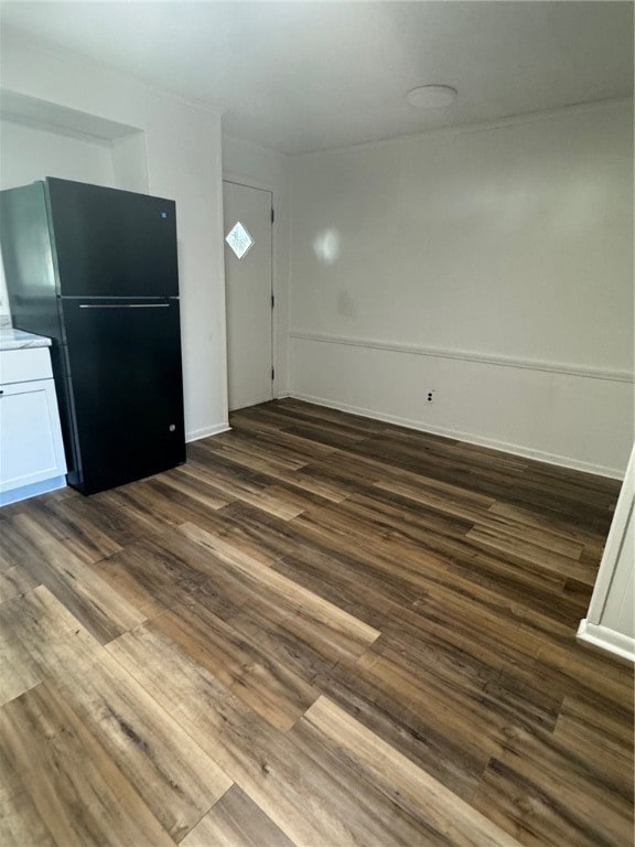 unfurnished living room with dark wood-type flooring