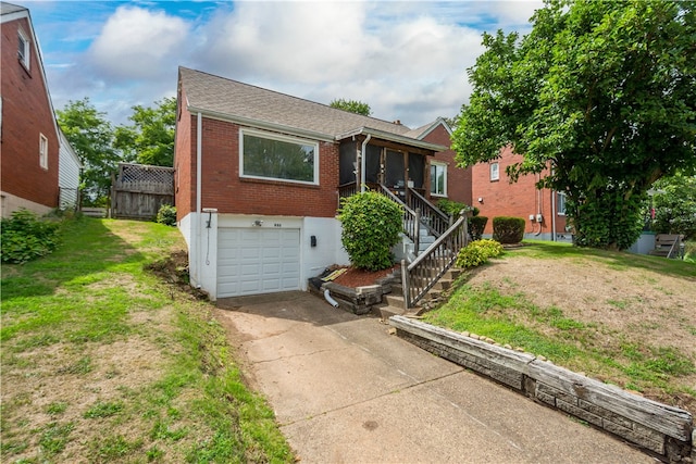 view of front of property with a garage and a front yard