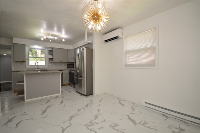 kitchen featuring appliances with stainless steel finishes, a wall unit AC, baseboard heating, gray cabinetry, and tasteful backsplash