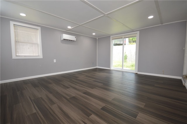 empty room with an AC wall unit and hardwood / wood-style floors