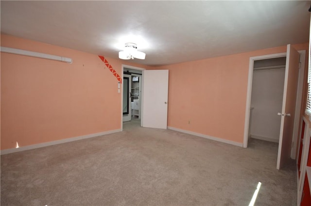 interior space featuring light carpet and baseboards