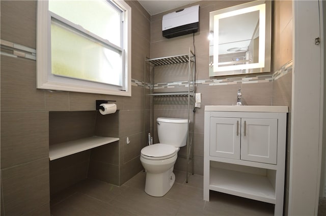 bathroom featuring tile walls, tile patterned floors, vanity, and toilet