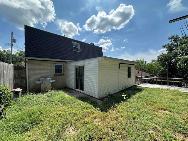 back of property featuring a lawn