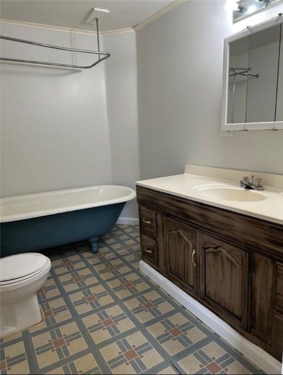 bathroom featuring ornamental molding, vanity, a bathing tub, and toilet