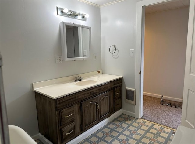 bathroom with vanity, heating unit, and ornamental molding