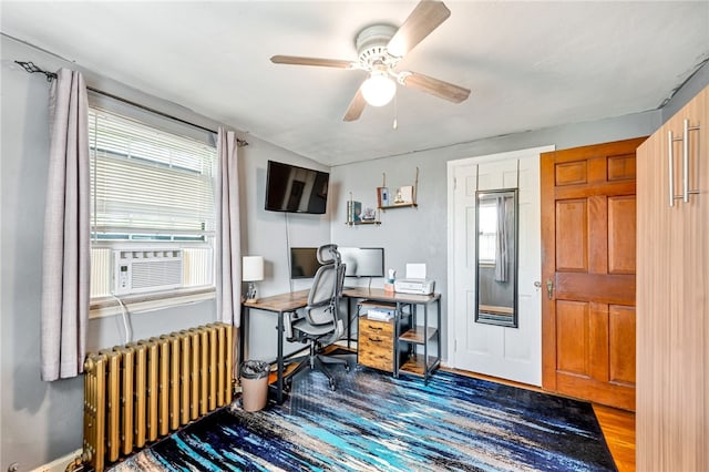 office with ceiling fan, radiator heating unit, and wood-type flooring