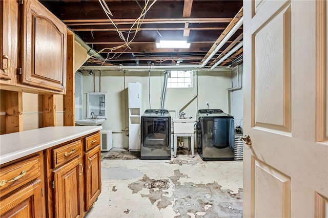 basement featuring washer and dryer and sink