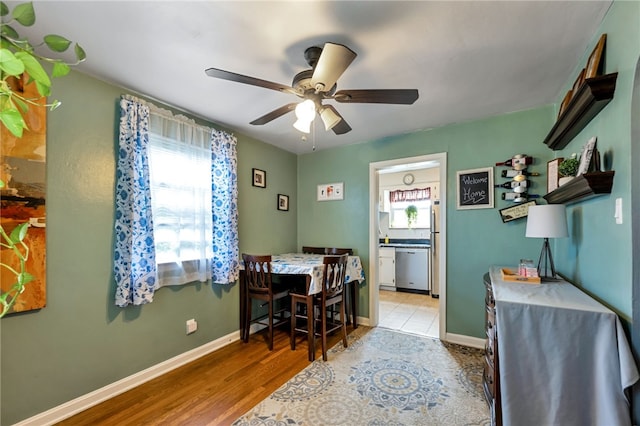 tiled home office with plenty of natural light and ceiling fan