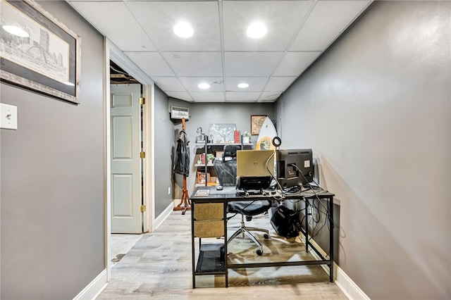 office with a paneled ceiling and light hardwood / wood-style floors