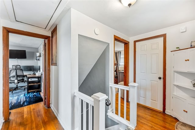 hallway with light hardwood / wood-style floors