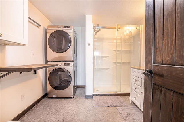 clothes washing area with light tile patterned flooring and stacked washer and dryer