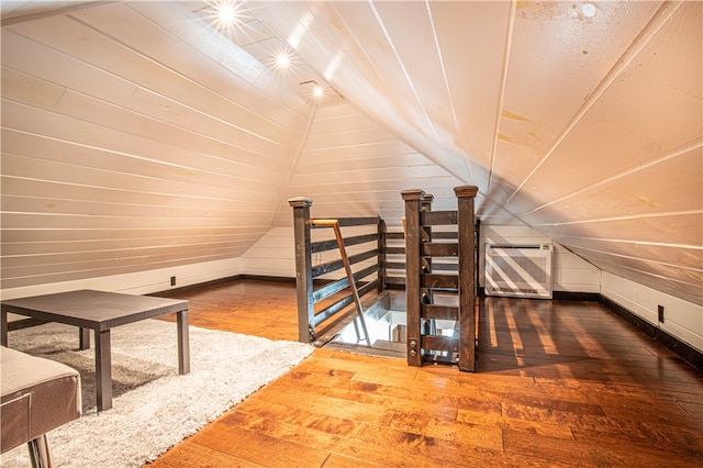 bonus room with hardwood / wood-style floors and lofted ceiling