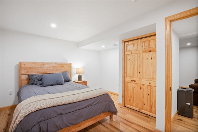 bedroom featuring light hardwood / wood-style flooring and a closet