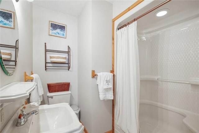 bathroom featuring sink and toilet