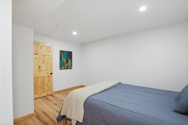 bedroom featuring recessed lighting, baseboards, and wood finished floors