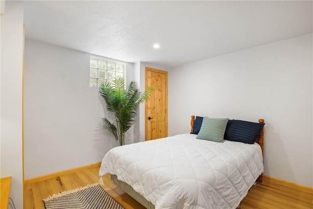 bedroom featuring recessed lighting, wood finished floors, and baseboards