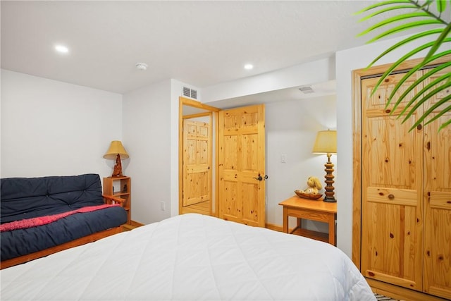 bedroom featuring baseboards, visible vents, and recessed lighting