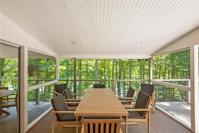 sunroom with wood ceiling, lofted ceiling, and a wealth of natural light