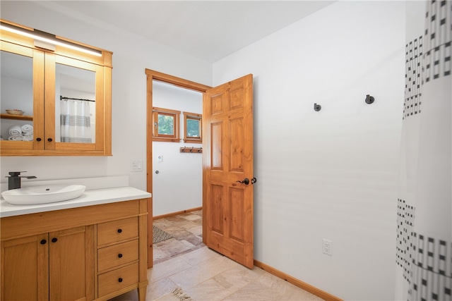 bathroom with tile patterned floors and vanity