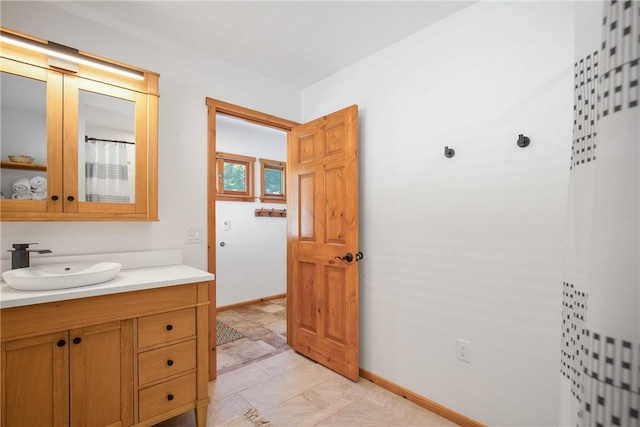 bathroom with vanity and baseboards