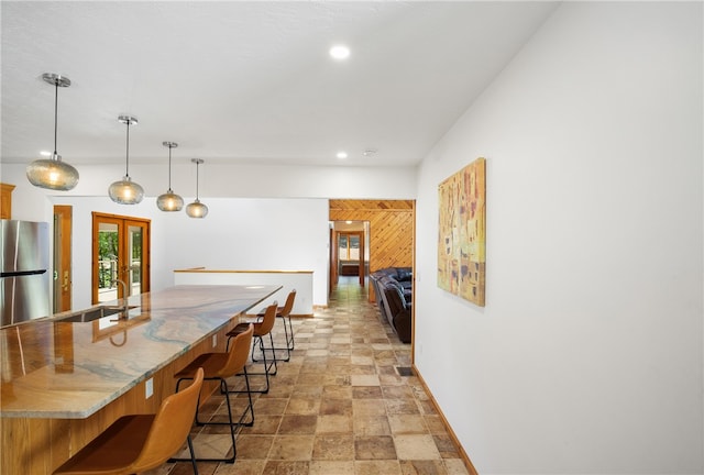 dining area featuring light tile patterned floors, french doors, and sink