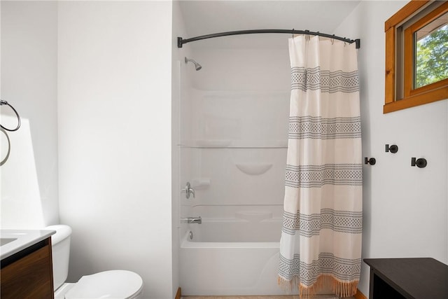 bathroom featuring toilet, shower / bath combo, and vanity