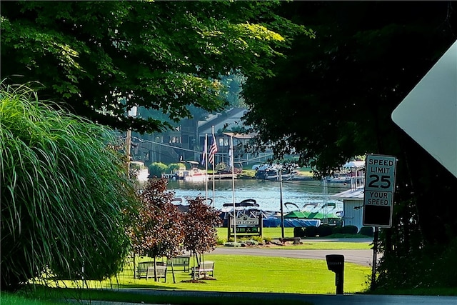 view of home's community featuring a yard and a water view