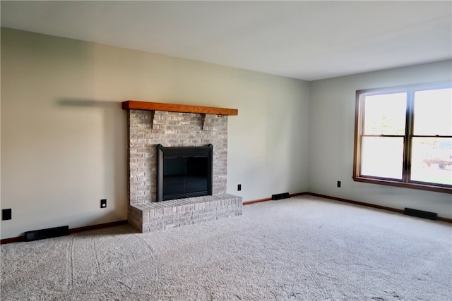 unfurnished living room featuring carpet floors and a fireplace