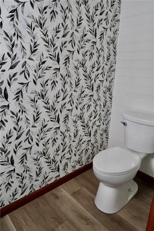 bathroom with toilet and hardwood / wood-style floors